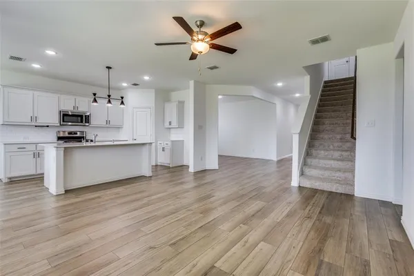 a view of kitchen with wooden floor and electronic appliances