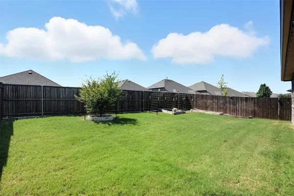 a view of a backyard with sitting area