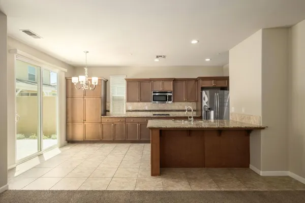 a spacious bathroom with a granite countertop sink a mirror and a shower