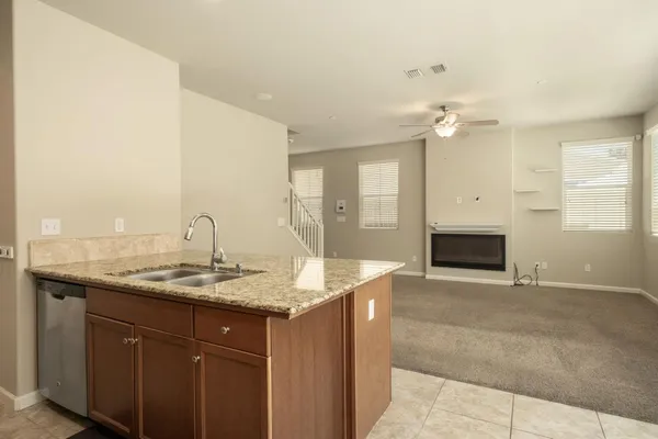 a kitchen with stainless steel appliances granite countertop a refrigerator and a stove top oven