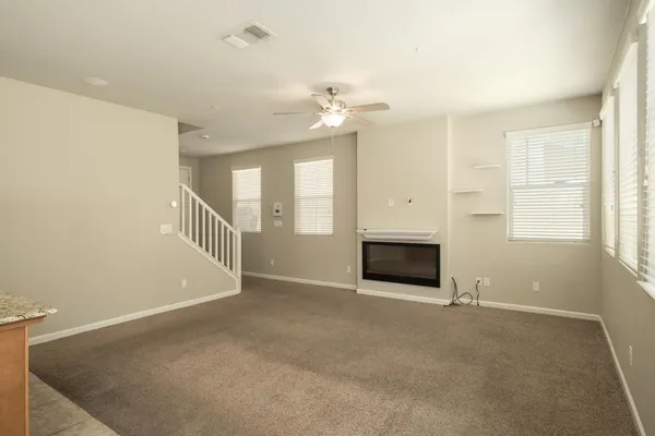 a view of a hallway with a white door and a window