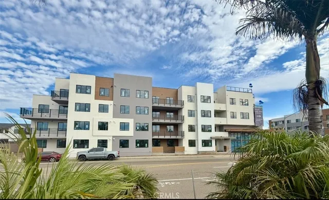 a front view of a building with a garden