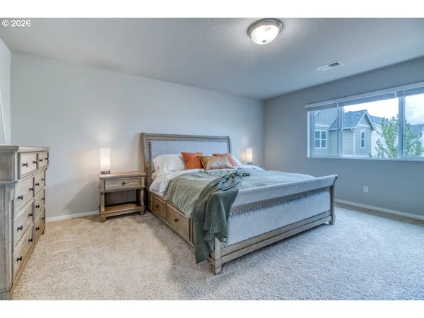 a bedroom with a bed and window