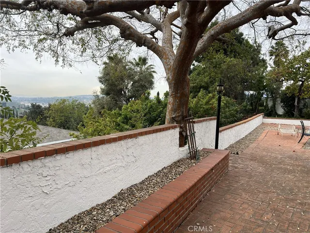 a view of a balcony with trees