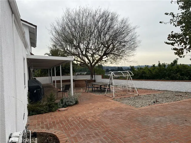 a view of house with backyard and outdoor seating