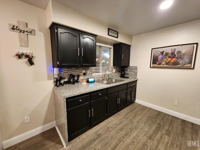 a spacious bathroom with a granite countertop sink and a mirror