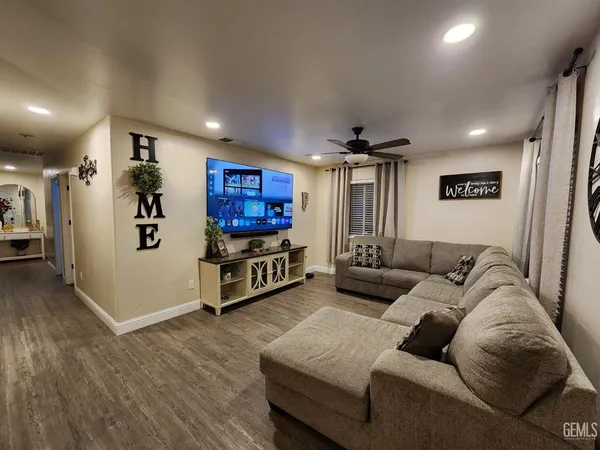 a living room with furniture and wooden floor