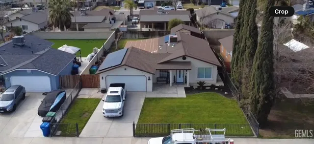 an aerial view of a house with garden space and street view