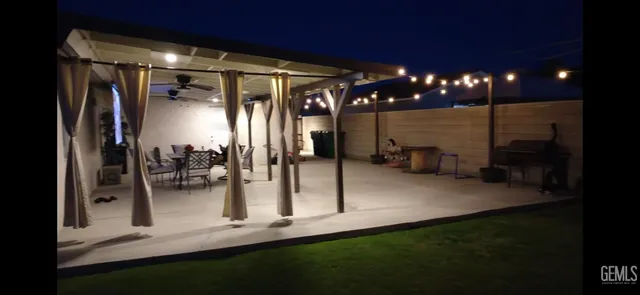 a view of a porch with dining table and chairs