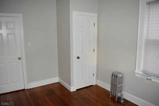 a view of room with wooden floor and closet