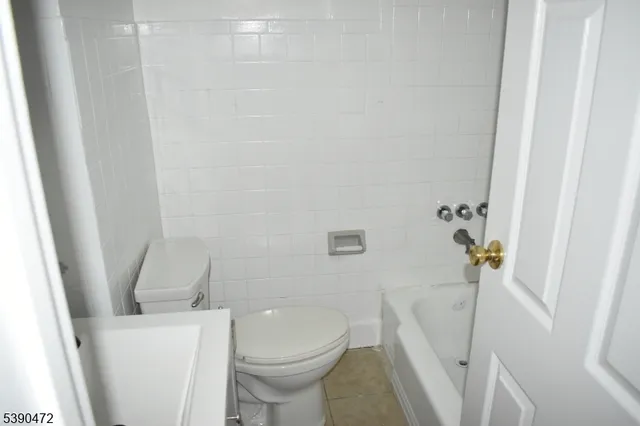 a white toilet sitting next to a white sink