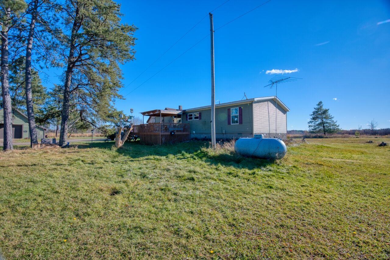 3932 Hwy 100 Aurora Mn 55705 Aurora, MN 55705 - Photo 22 of 44 Rear view of house with a lawn and a deck