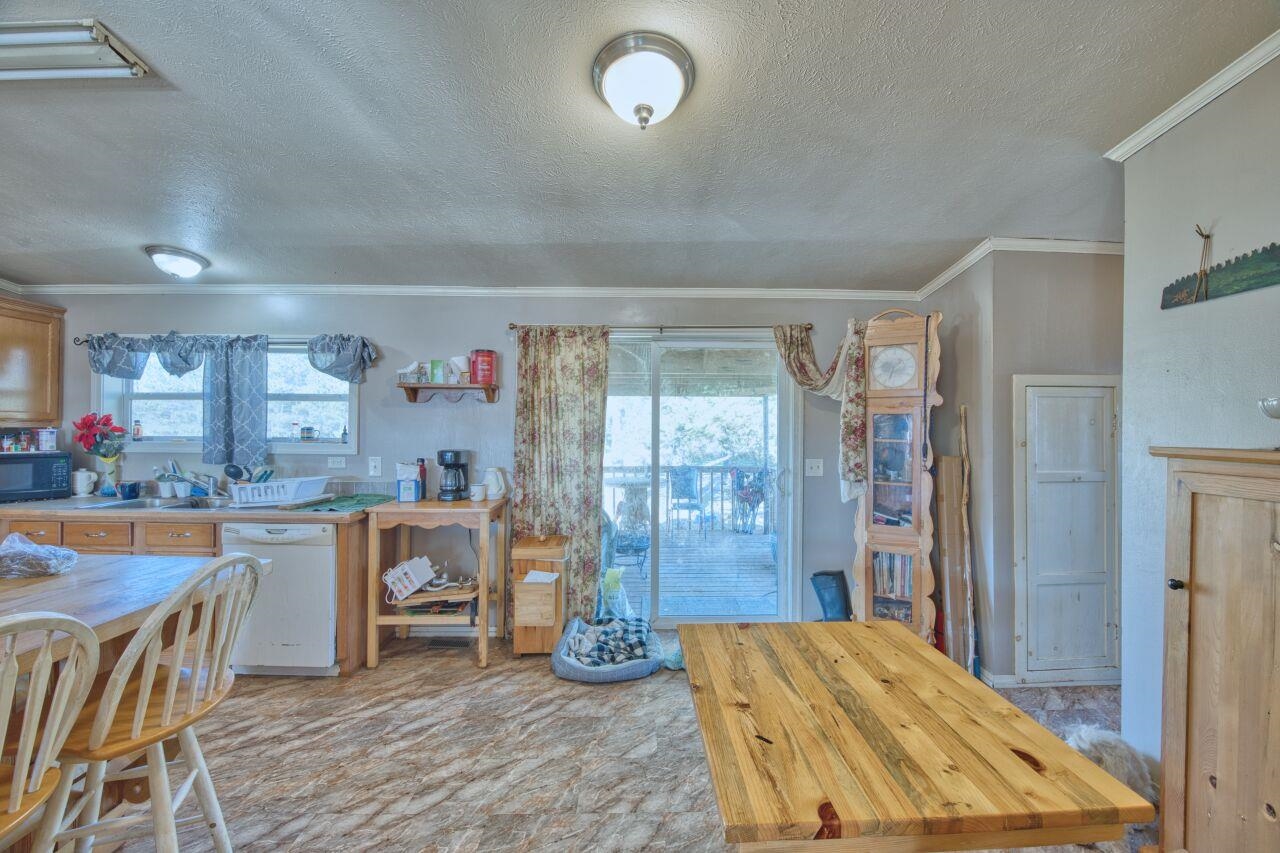3932 Hwy 100 Aurora Mn 55705 Aurora, MN 55705 - Photo 10 of 44 Kitchen with crown molding, a textured ceiling, dishwasher, plenty of natural light, and black microwave