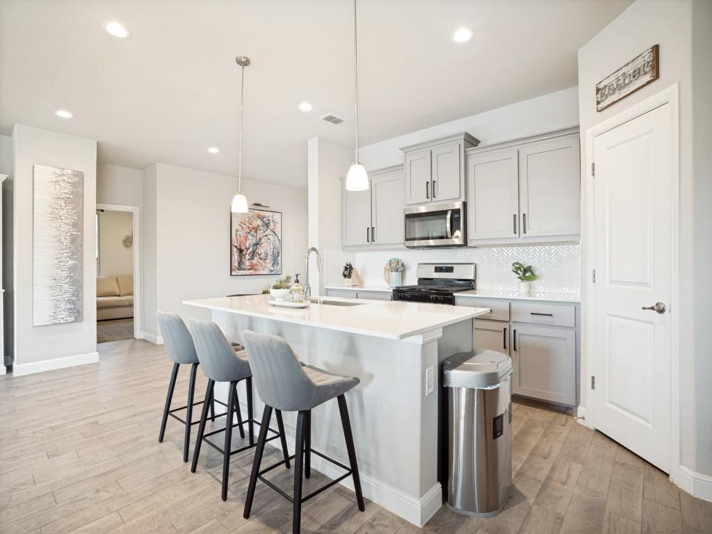 1612 Reed Drive Krum, TX 76249 - Photo 5 of 25 Central kitchen island with white countertop