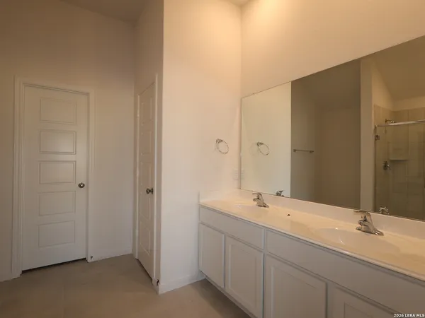 a bathroom with a double vanity sink and mirror