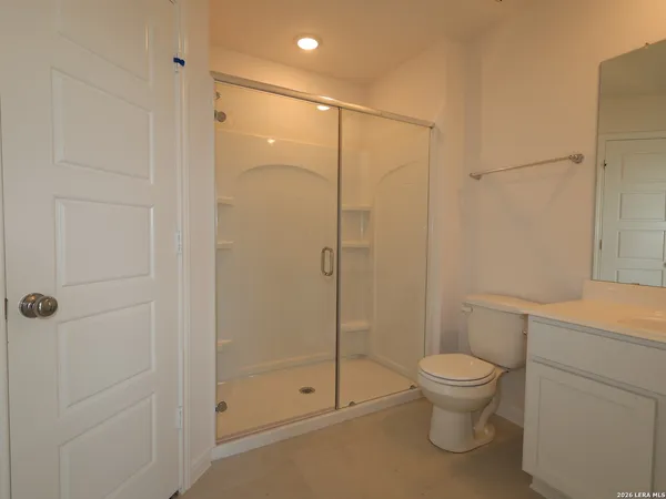 a bathroom with a toilet and a shower