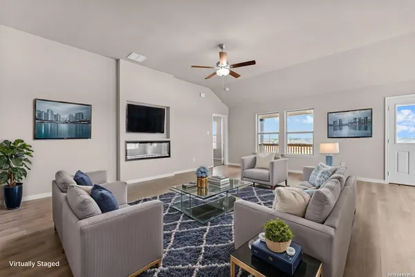 a living room with furniture a window and a flat screen tv