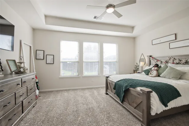 a spacious bedroom with a bed and a window