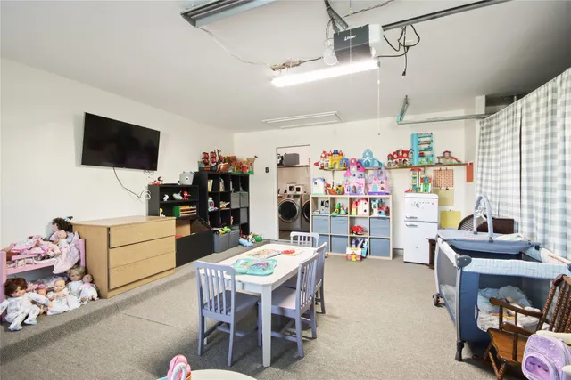 a room with furniture a flat screen tv and a window