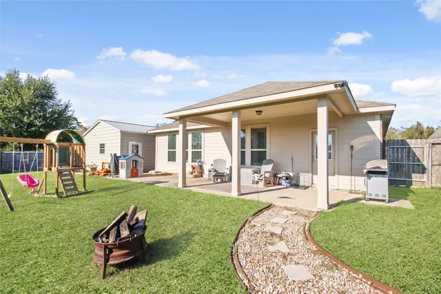 a view of a house with backyard porch and sitting area