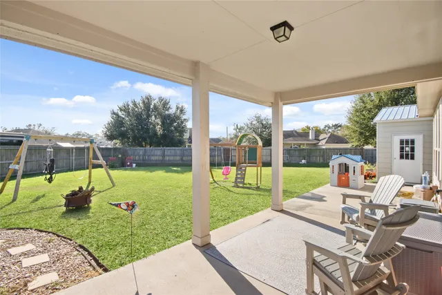 a view of backyard with a table and chairs