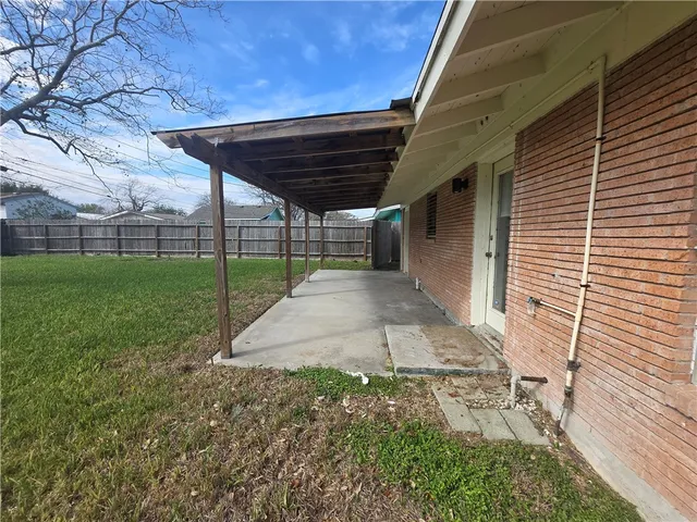 a view of a backyard with wooden fence