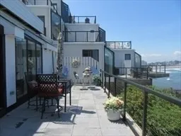 a view of a patio with table and chairs potted plants