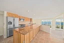 a kitchen with stainless steel appliances granite countertop a refrigerator and a stove