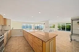 a large white kitchen with a large window