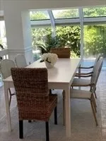 a living room with chairs and a table