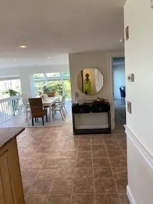 a living room with fireplace furniture and a large window
