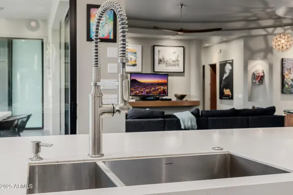 a room with pool table and paintings on the wall
