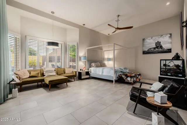 a livingroom with workspace couch and a window