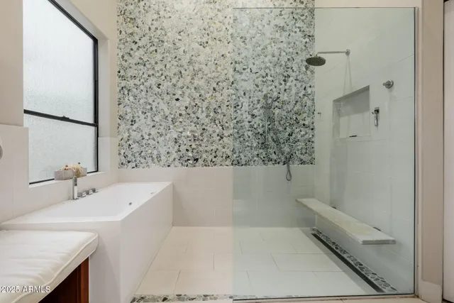 a spacious bedroom with two beds and a large mirror