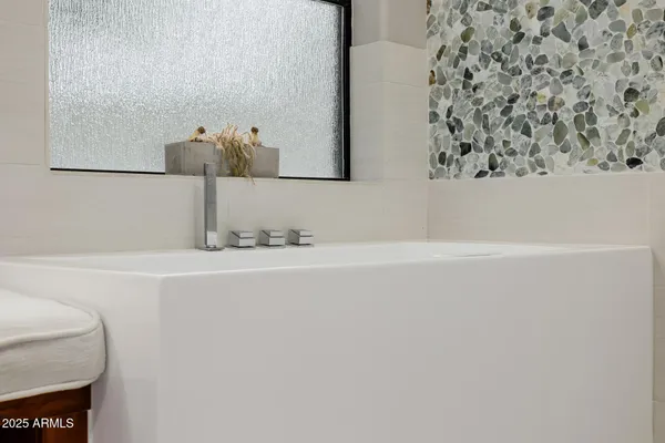 a bedroom with a bed and a table