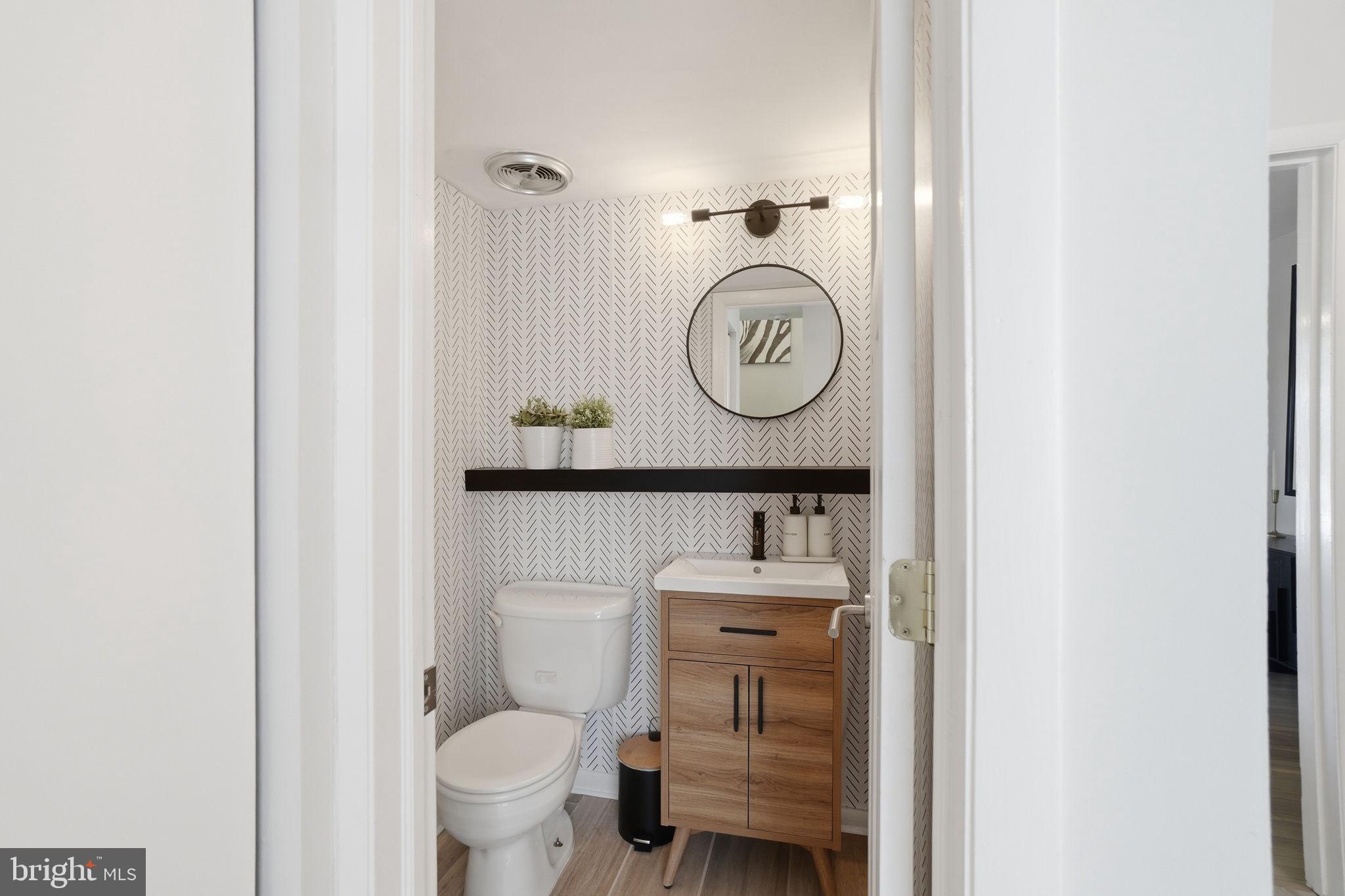 11025 Saffold Way Reston, VA 20190 - Photo 11 of 50 a bathroom with a toilet a sink and a mirror