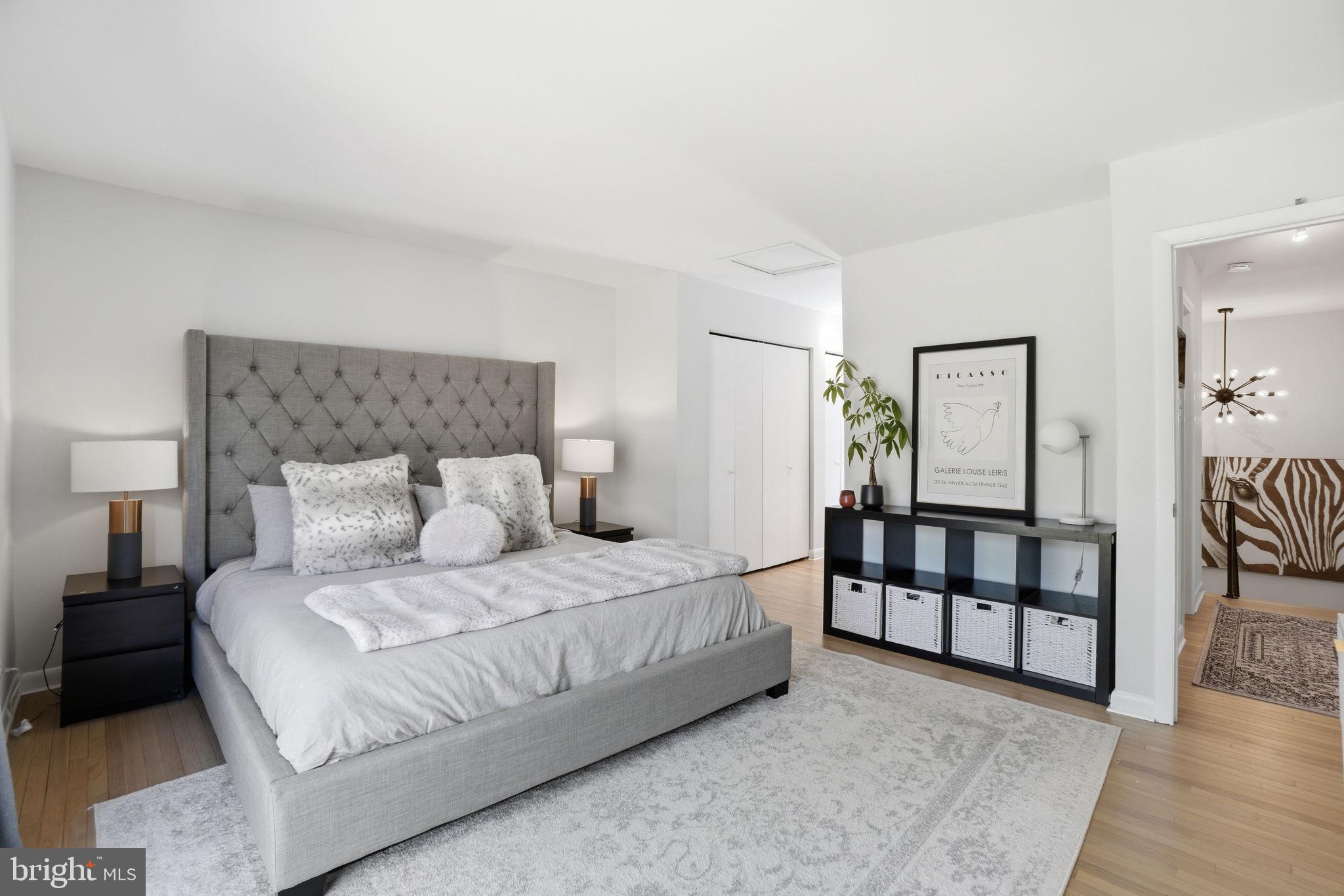 11025 Saffold Way Reston, VA 20190 - Photo 13 of 50 a bedroom with a bed and a night stand