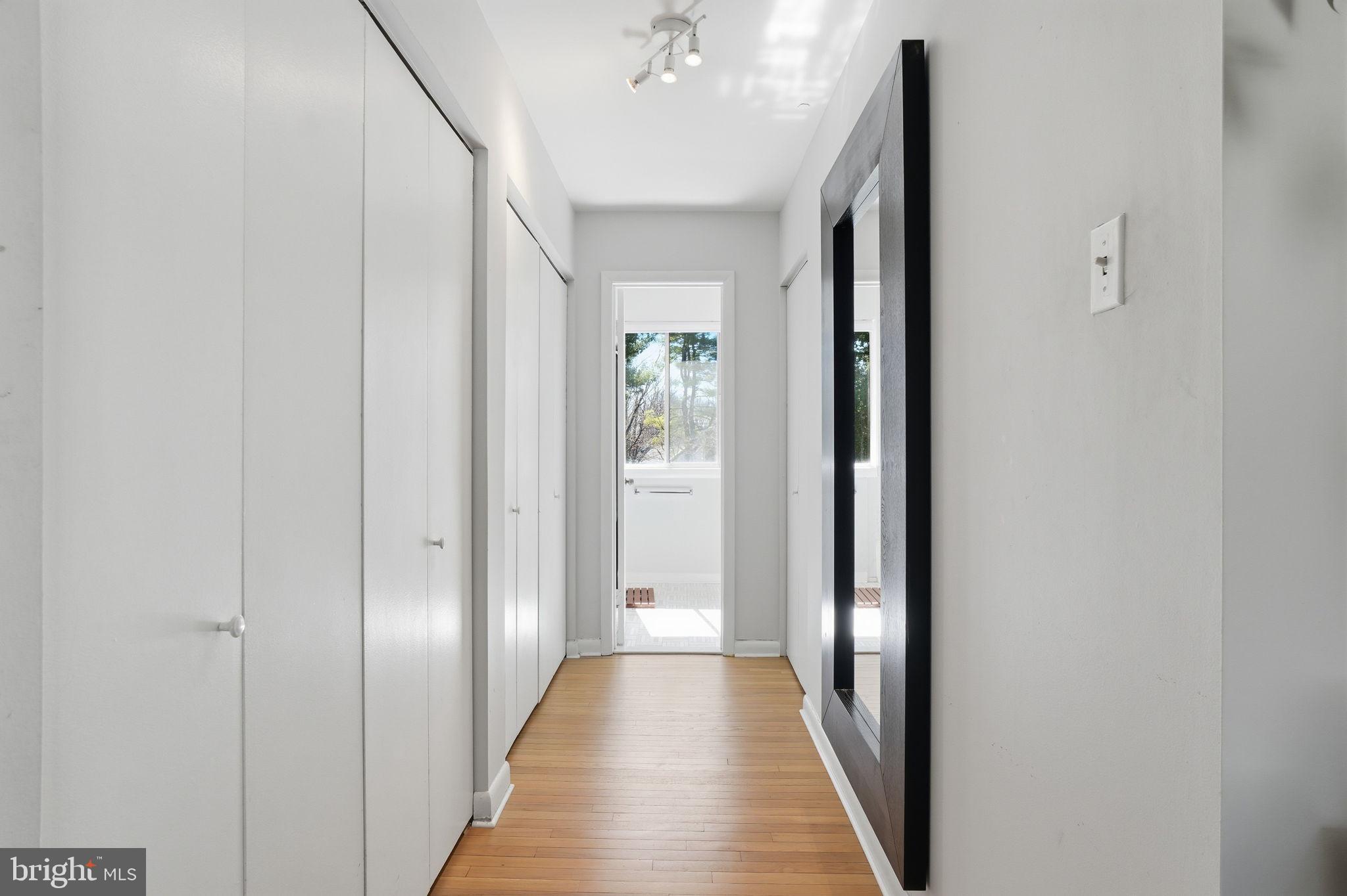 11025 Saffold Way Reston, VA 20190 - Photo 14 of 50 a view of a hallway with wooden floor and closet