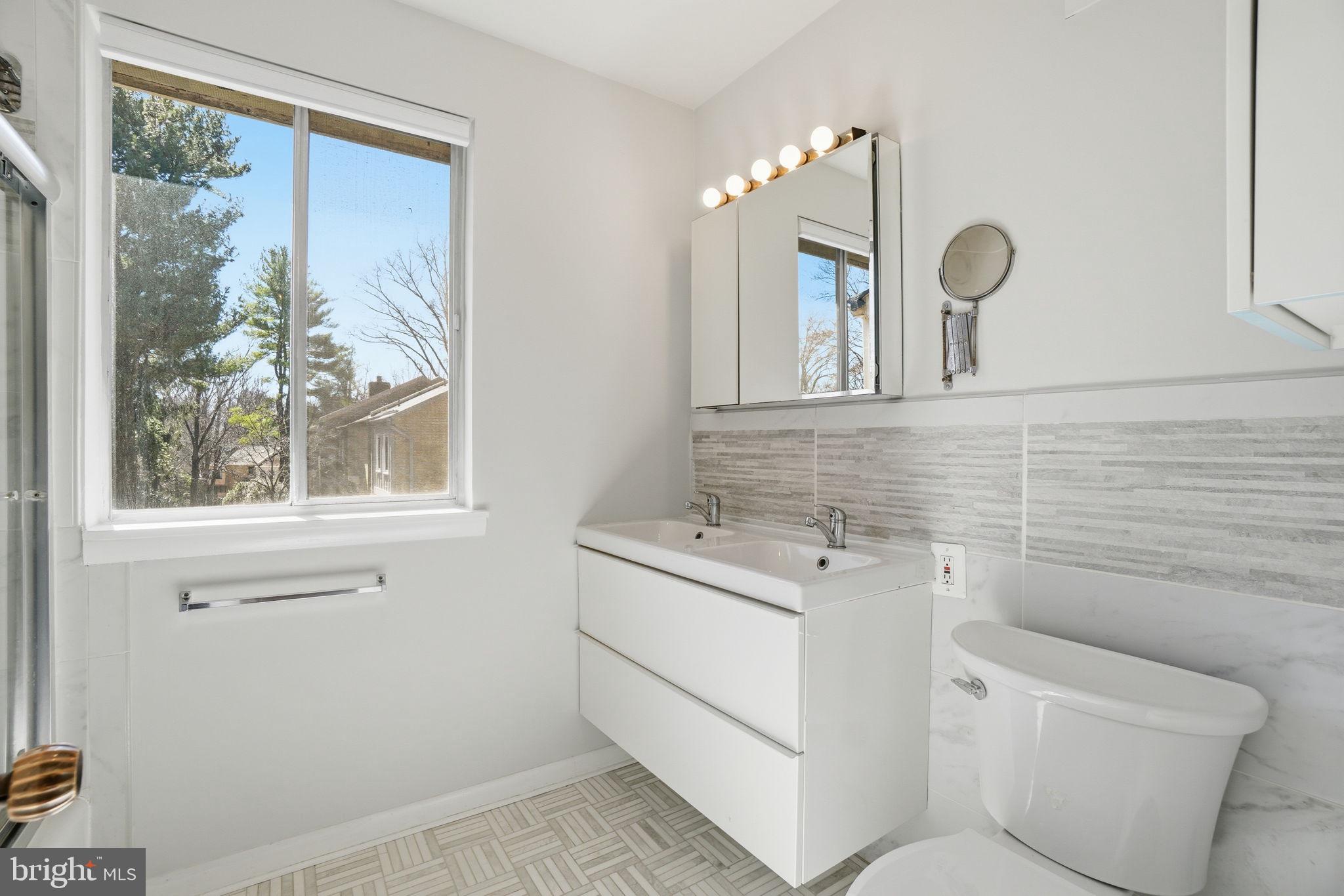 11025 Saffold Way Reston, VA 20190 - Photo 15 of 50 a bathroom with a toilet sink and mirror