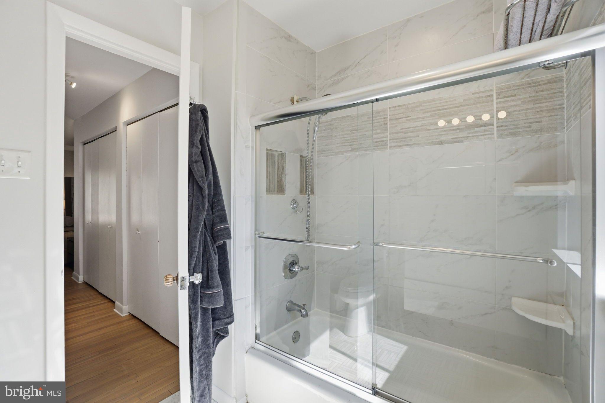 11025 Saffold Way Reston, VA 20190 - Photo 16 of 50 a bathroom with a glass shower door and sink