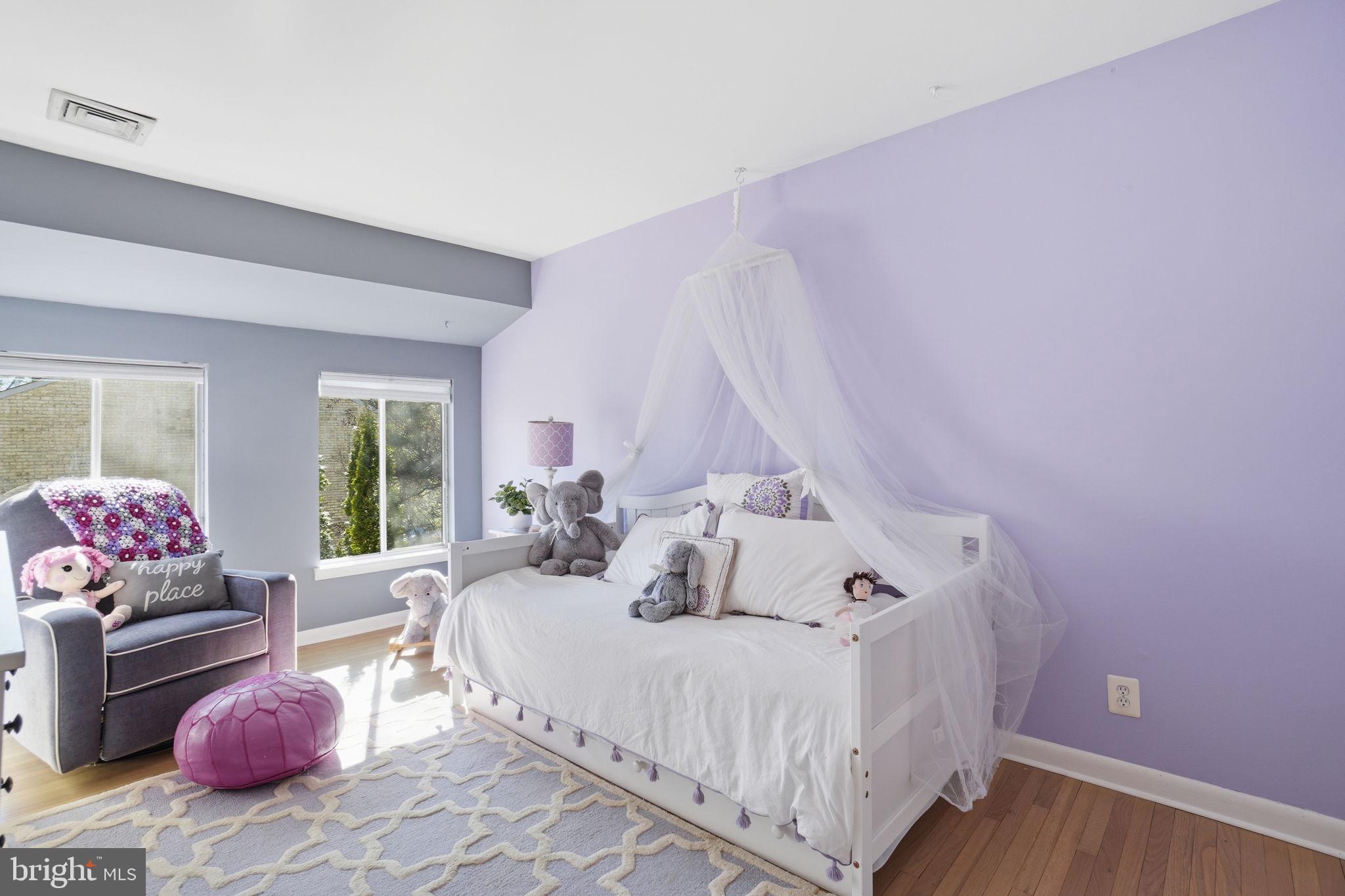 11025 Saffold Way Reston, VA 20190 - Photo 17 of 50 a bedroom with a bed and wooden floor