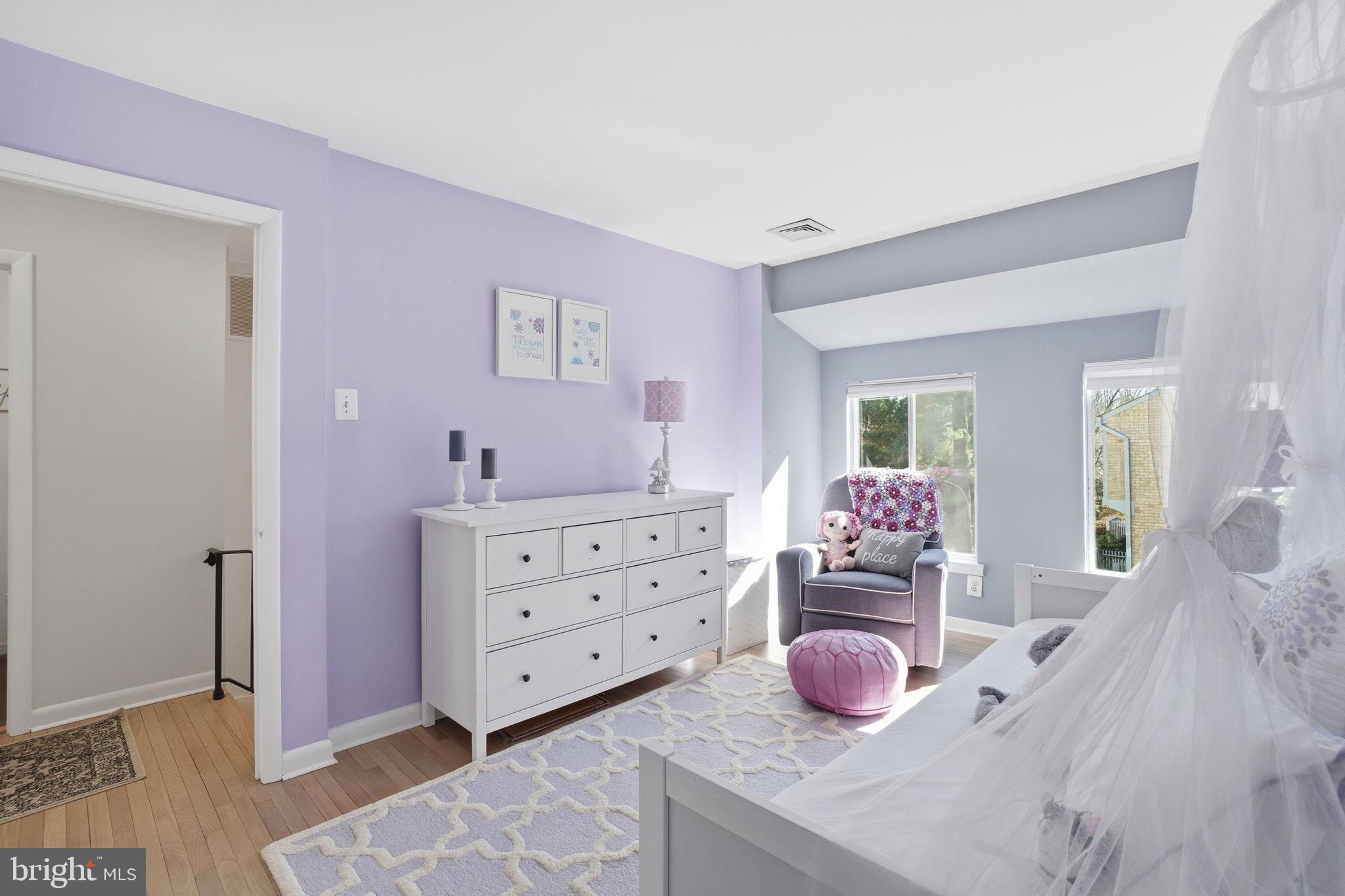 11025 Saffold Way Reston, VA 20190 - Photo 18 of 50 a bedroom with a bed and dresser