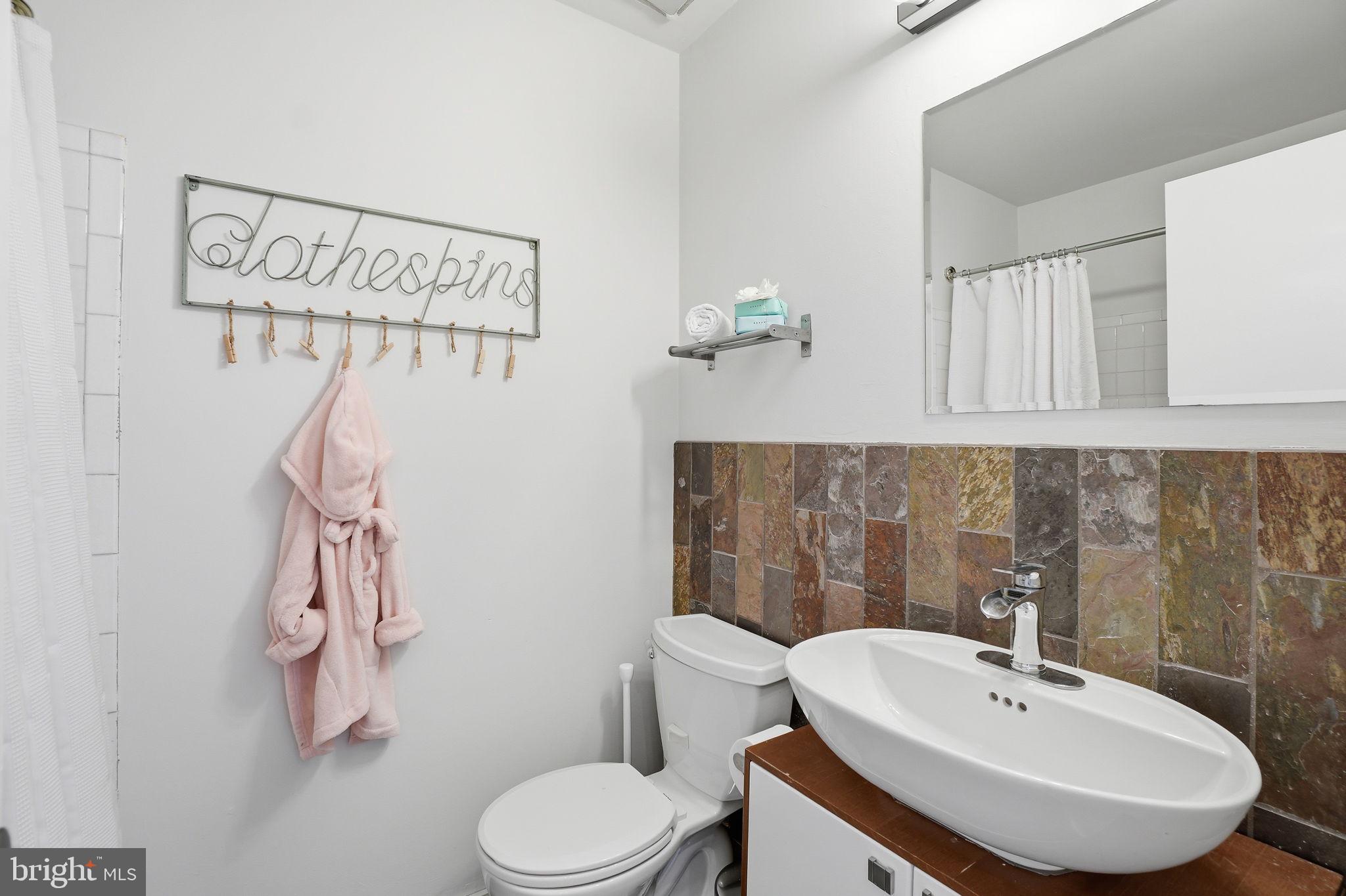 11025 Saffold Way Reston, VA 20190 - Photo 22 of 50 a bathroom with a sink a mirror and toilet