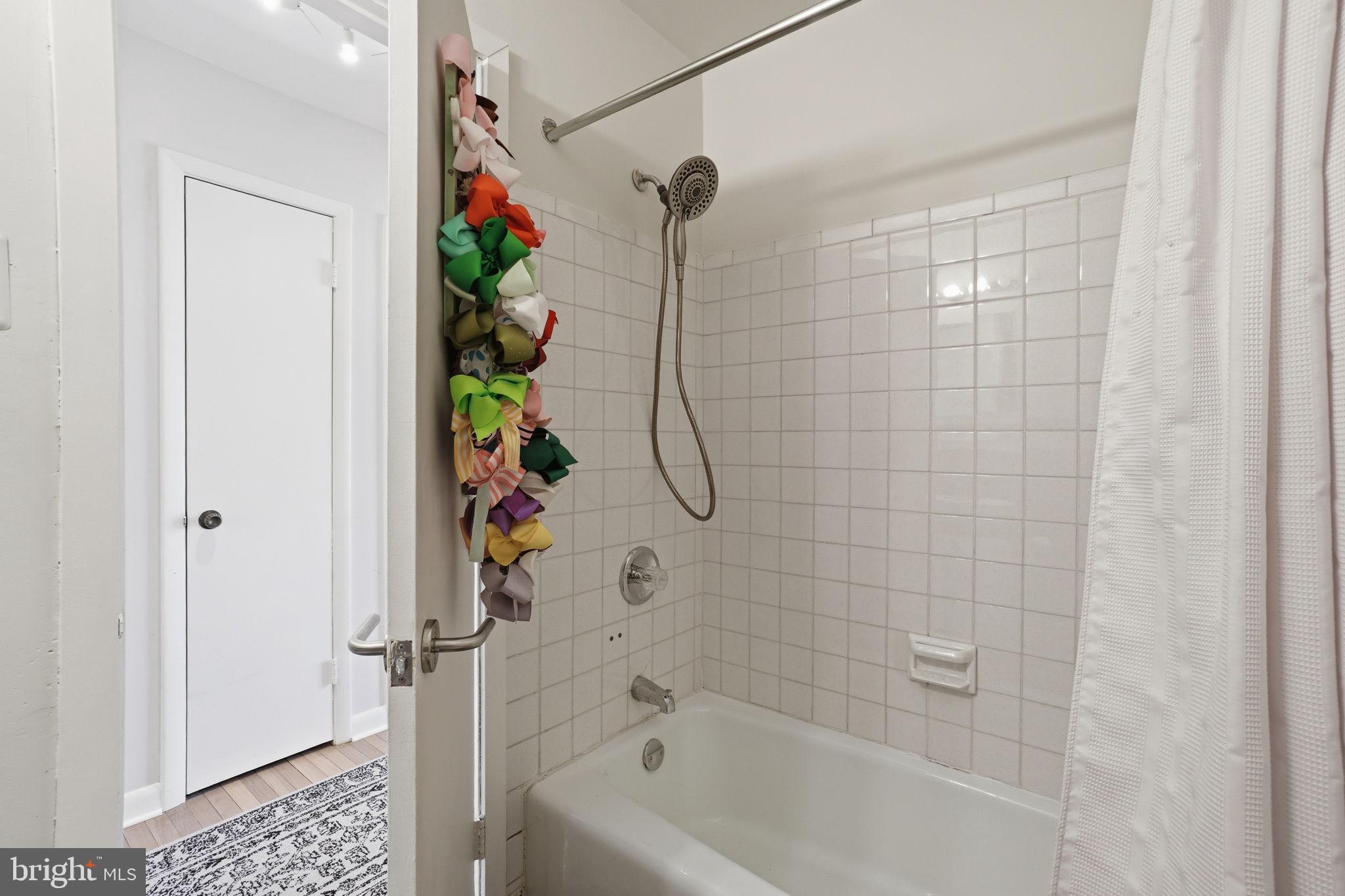 11025 Saffold Way Reston, VA 20190 - Photo 23 of 50 a bathroom with a bathtub and a shower