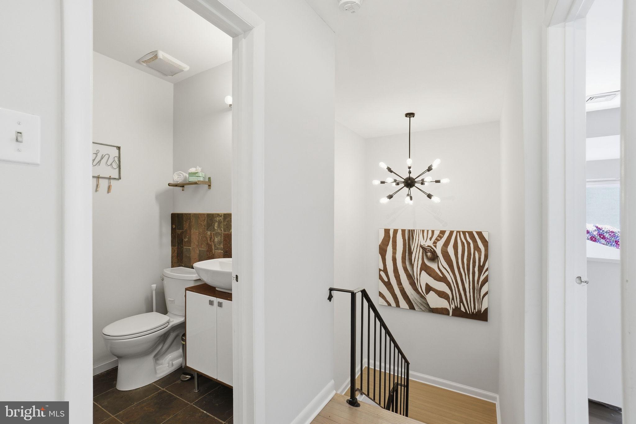 11025 Saffold Way Reston, VA 20190 - Photo 24 of 50 a bathroom with a toilet sink and mirror