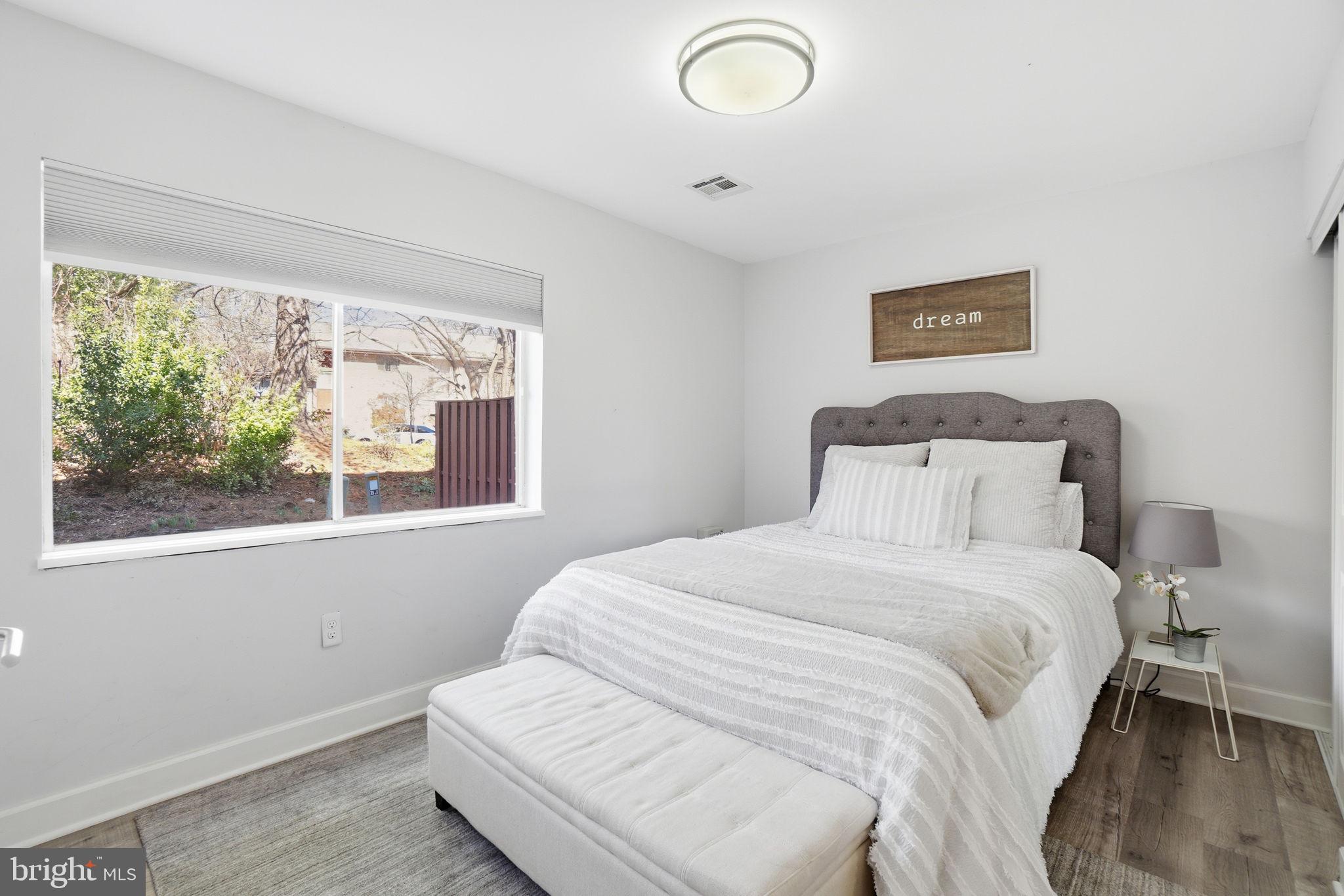 11025 Saffold Way Reston, VA 20190 - Photo 28 of 50 a bedroom with a bed and a window