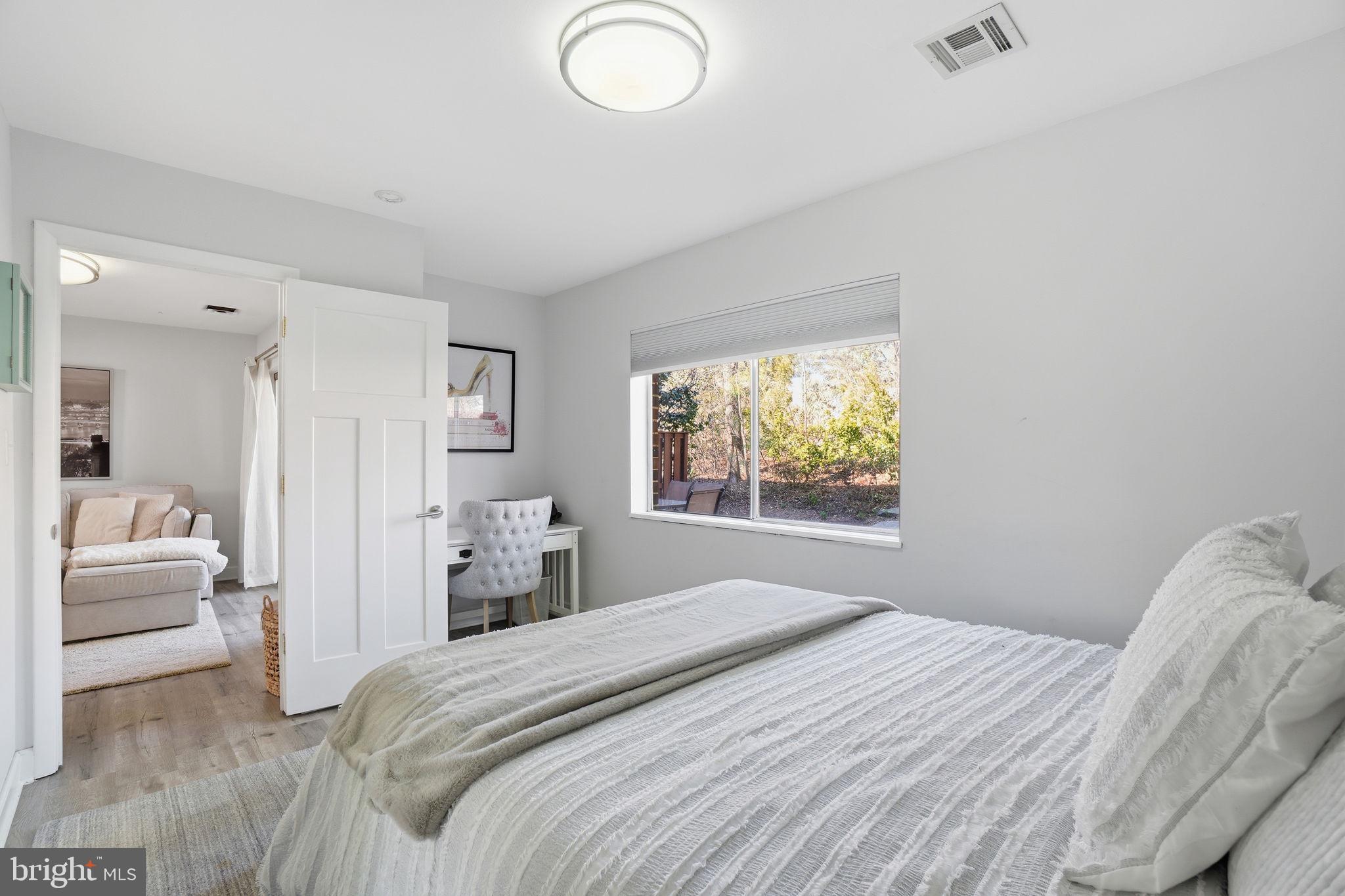 11025 Saffold Way Reston, VA 20190 - Photo 29 of 50 a bedroom with a bed and a couch