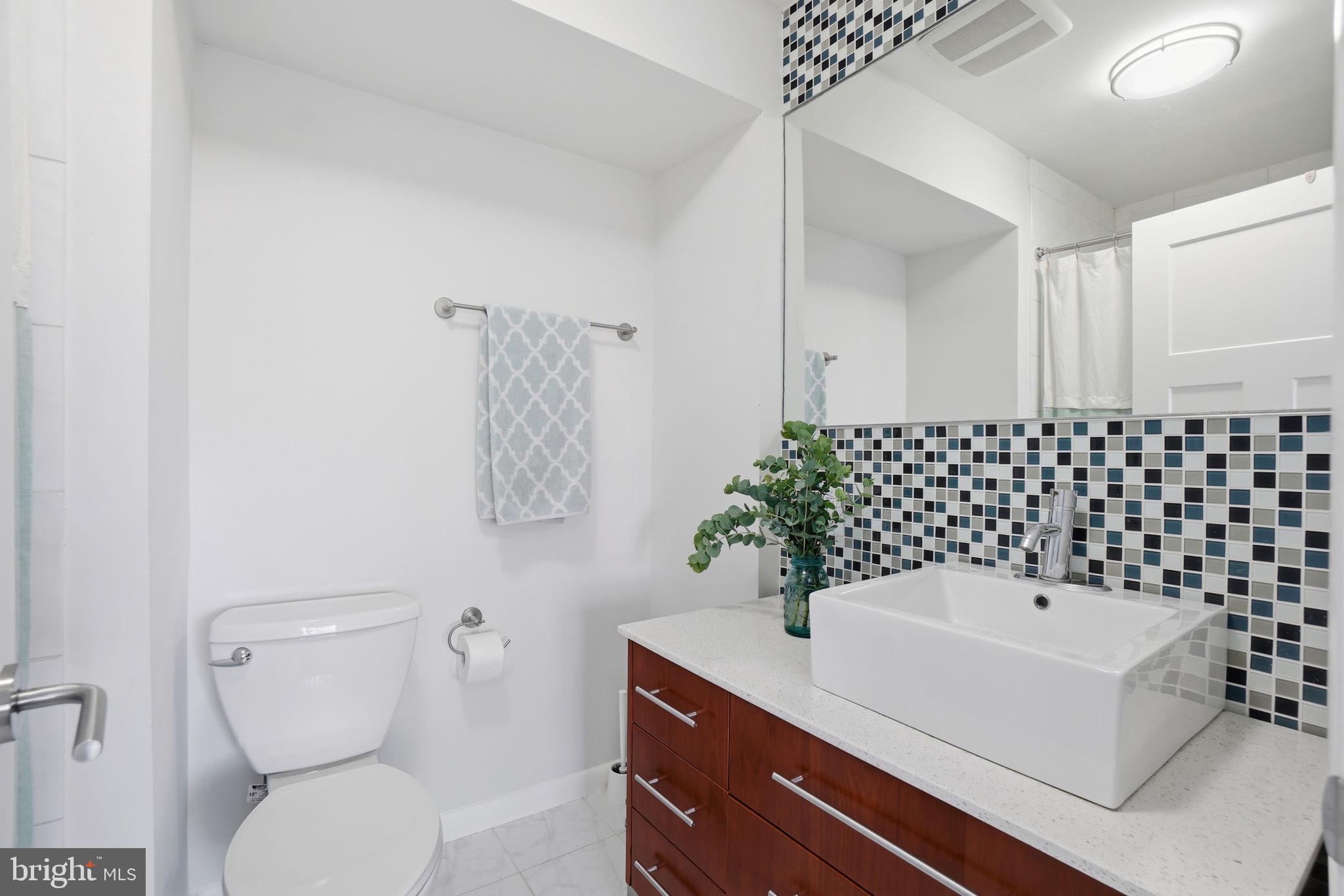 11025 Saffold Way Reston, VA 20190 - Photo 30 of 50 a bathroom with a sink toilet and shower