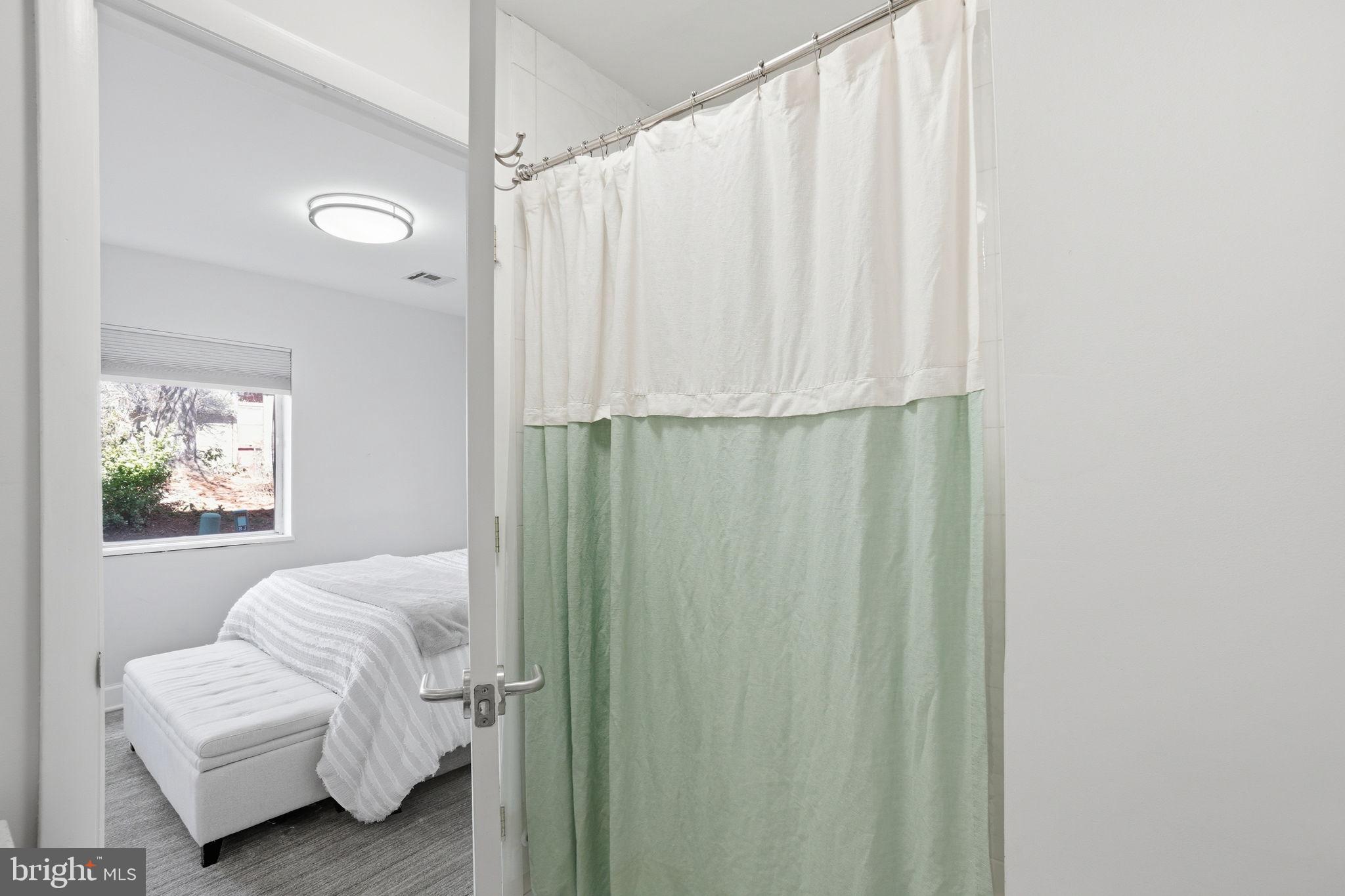 11025 Saffold Way Reston, VA 20190 - Photo 31 of 50 a bedroom with a bed and a chair