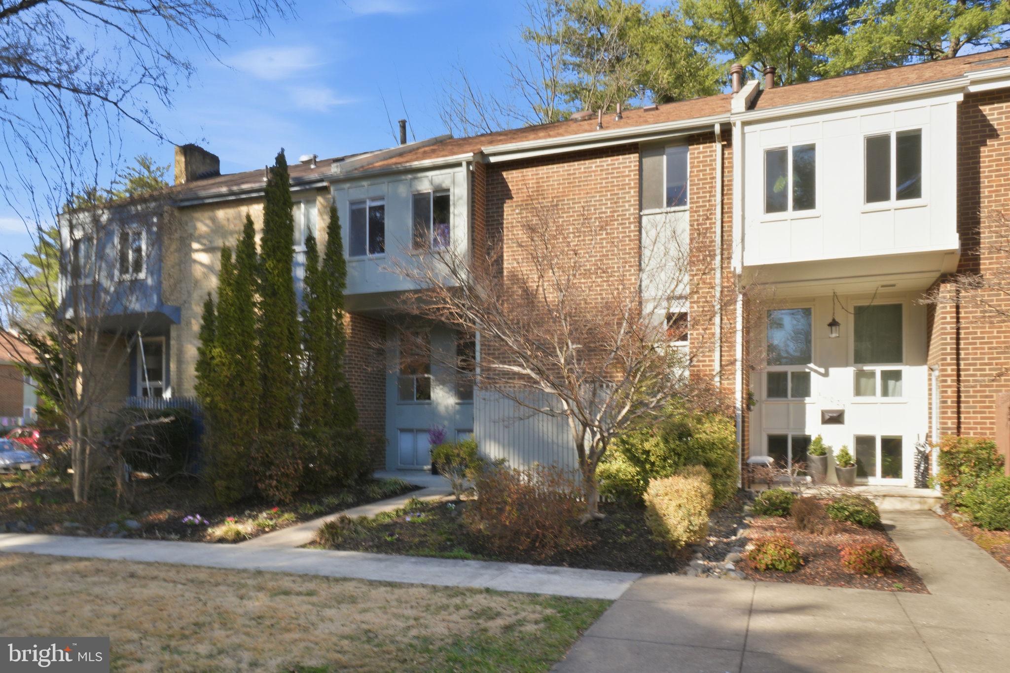 11025 Saffold Way Reston, VA 20190 - Photo 36 of 50 a front view of a house with a yard
